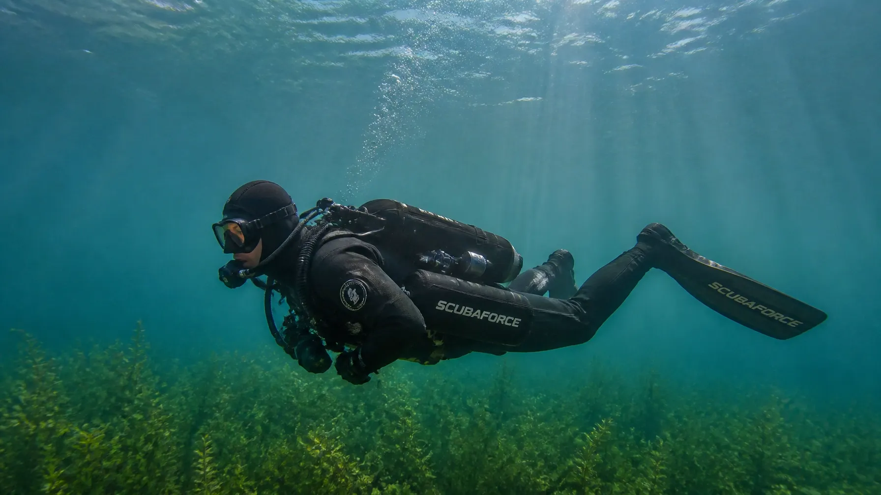 Taucher im Trockenanzug über den Unterwasserwiesen des Goitzschesees